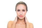 Frowning brunette woman having a sore neck