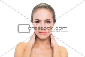 Frowning brunette woman having a sore neck