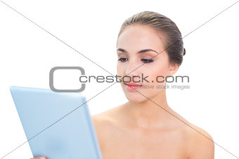Content brunette woman holding a tablet