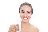 Cheerful brunette woman holding a glass of milk
