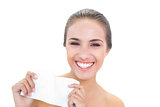 Smiling brunette woman holding a tissue