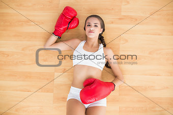 Sporty brunette woman having red boxing gloves on