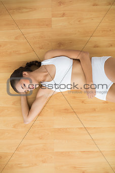 Content sporty brunette closing her eyes