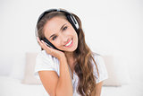 Cheerful attractive brunette listening to music