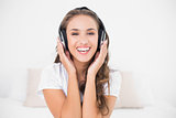 Happy attractive brunette listening to music