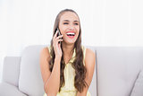Laughing pretty brunette using mobile phone
