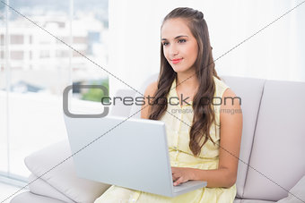Content pretty brunette using laptop