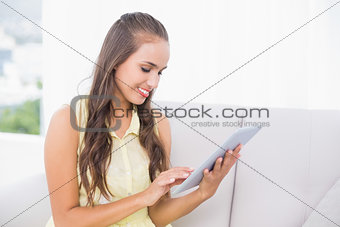 Content young brunette using tablet