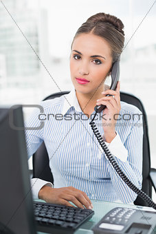 Calm brunette businesswoman phoning