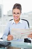 Cheerful brunette businesswoman holding documents
