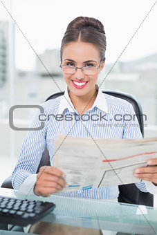 Cheerful brunette businesswoman holding documents