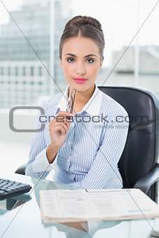 Content brunette businesswoman holding glasses