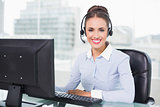 Cheerful brunette businesswoman using headset