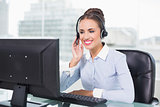 Smiling businesswoman using headset