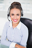 Smiling brunette businesswoman wearing a headset