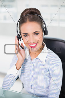 Cheerful brunette businesswoman wearing a headset
