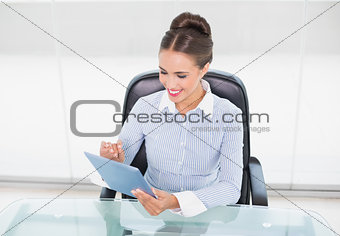 Content brunette businesswoman using tablet