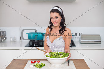 Cheerful pretty brunette preparing healthy salad