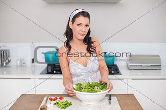 Content pretty brunette preparing healthy salad