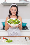 Happy pretty brunette holding healthy salad