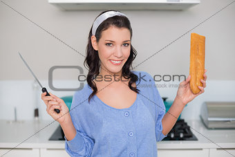 Cheerful gorgeous model holding knife and bread