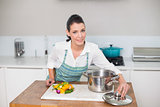 Content pretty woman wearing apron cooking