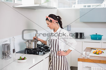 Focused pretty woman cooking