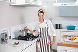Happy pretty woman with apron cooking