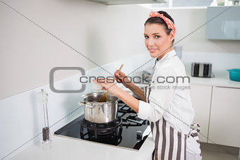 Cheerful pretty cook mixing vegetables