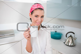 Smiling charming woman holding cup of tea