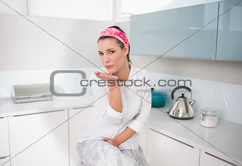 Content charming woman blowing air kiss