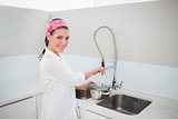 Smiling charming woman cleaning dishes