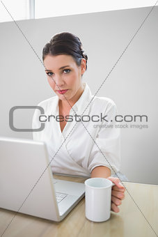 Charming businesswoman working on laptop
