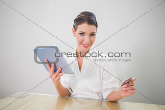 Cheerful pretty businesswoman shopping online