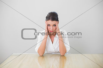 Anxious brown haired businesswoman posing