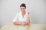 Smiling brown haired businesswoman posing