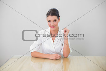 Smiling brown haired businesswoman posing
