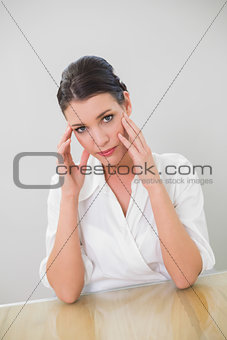 Serious brown haired businesswoman posing