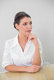 Pensive brown haired businesswoman posing