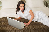 Content pretty brown haired woman using a laptop