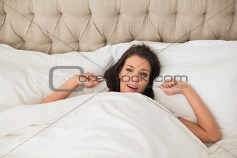 Content pretty brown haired woman waking up