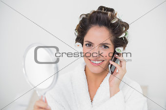 Smiling natural brunette using phone