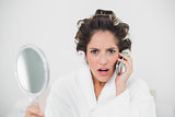 Shocked natural brunette phoning