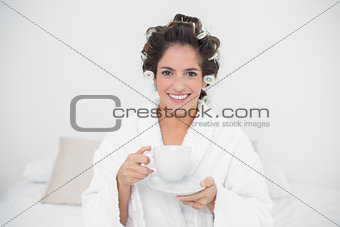 Happy natural brunette holding a mug