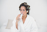 Peaceful natural brunette drinking glass of water