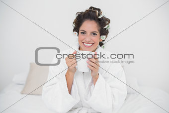 Cheerful natural brunette holding a mug