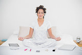 Relaxed natural brunette sitting in lotus pose
