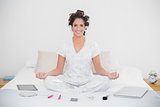 Cheerful natural brunette sitting in lotus pose