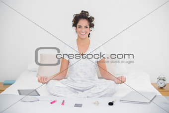 Cheerful natural brunette sitting in lotus pose