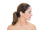 Peaceful bare brunette turning head right with closed eyes